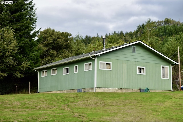 view of side of home featuring a yard