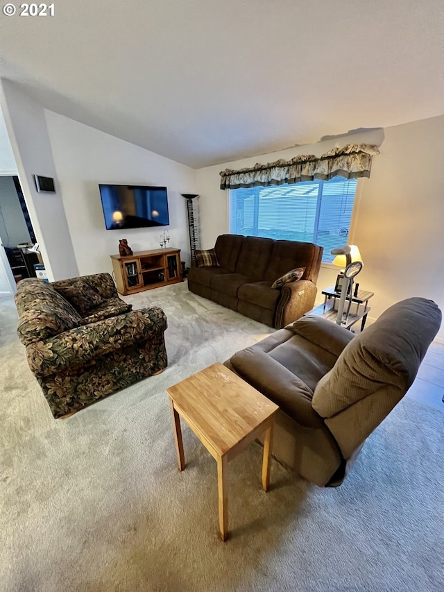 living room with lofted ceiling and carpet