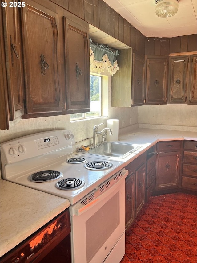 95851 Mckinnon Dr, Gold Beach, OR 97444 - kitchen featuring light countertops, white range with electric stovetop, and a sink