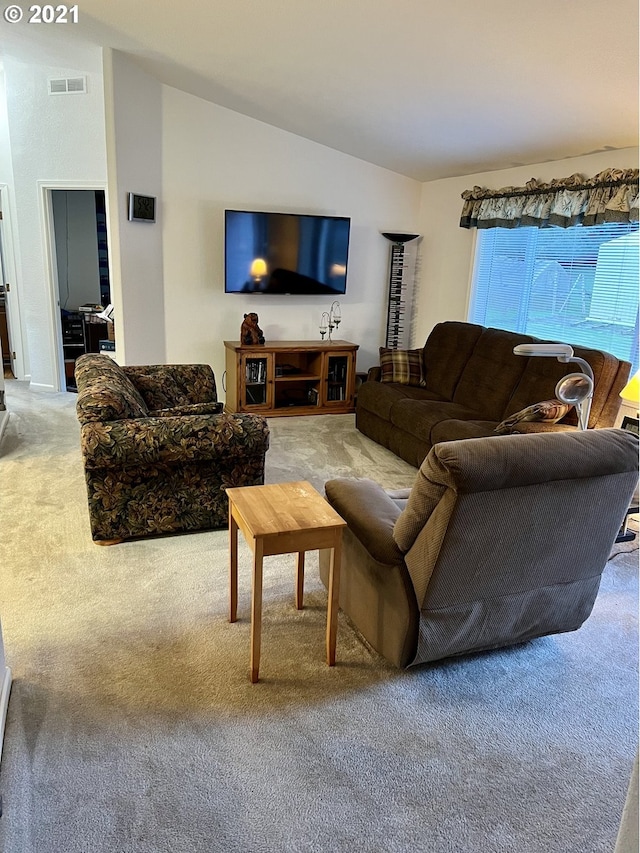 living room with lofted ceiling and light carpet