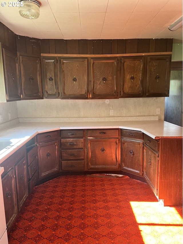 kitchen featuring dark brown cabinets