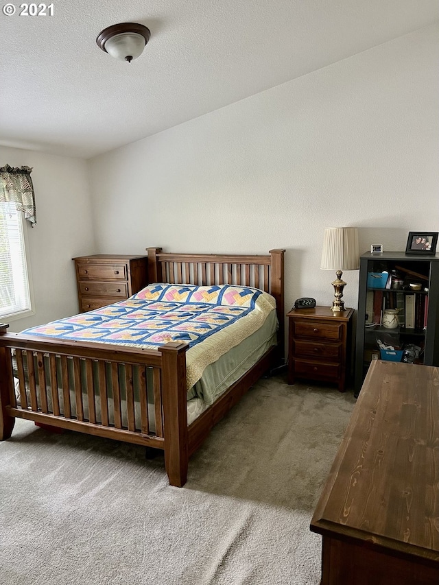 carpeted bedroom featuring a textured ceiling