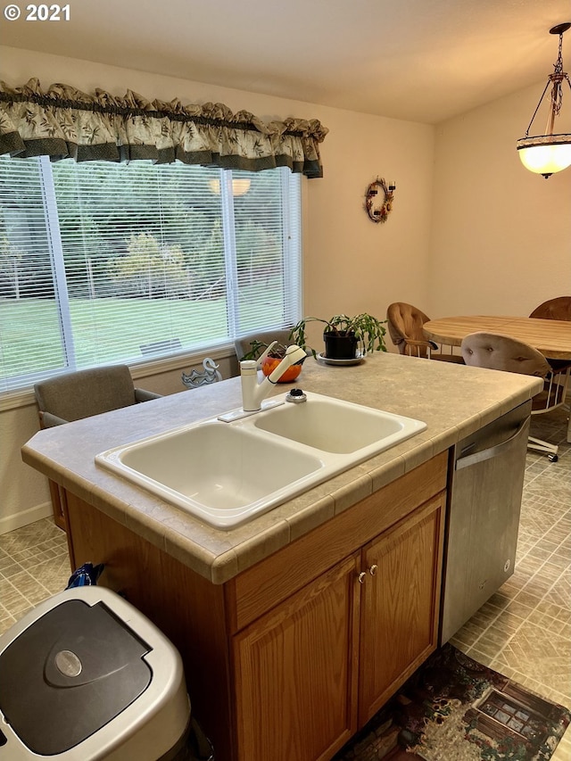 95851 Mckinnon Dr, Gold Beach, OR 97444 - kitchen featuring stainless steel dishwasher, pendant lighting, a kitchen island, tile counters, and a sink