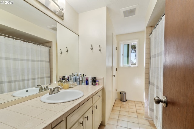 bathroom with tile patterned flooring and vanity