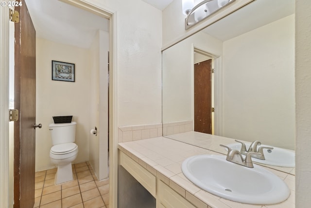 bathroom with tile patterned floors, toilet, and vanity