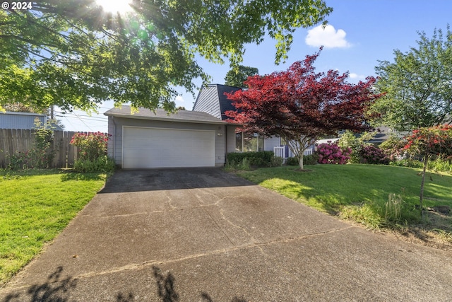 view of front of property with a garage and a front lawn