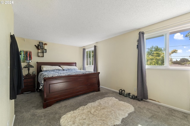 bedroom featuring light colored carpet and a textured ceiling