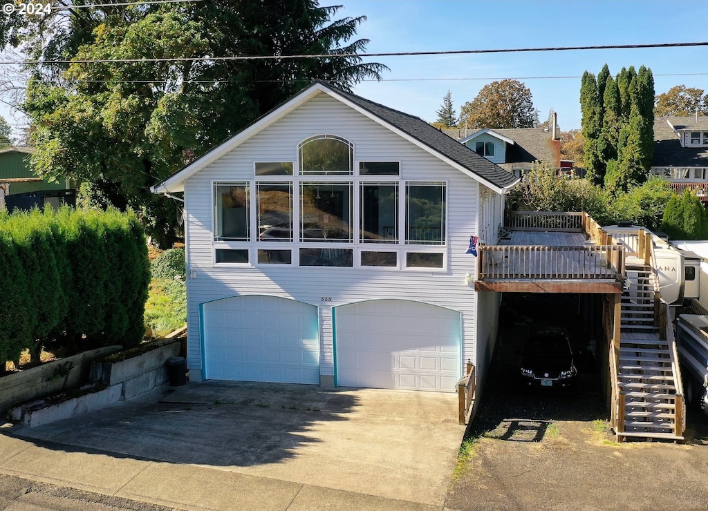 view of front of house featuring a deck and a garage