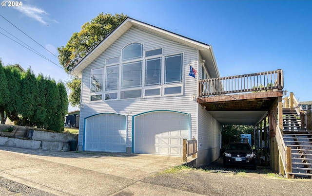 view of front of home with a wooden deck, a carport, and a garage