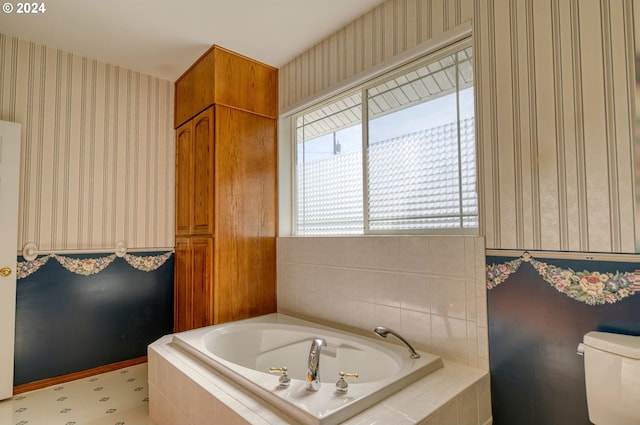 bathroom with tiled bath and toilet