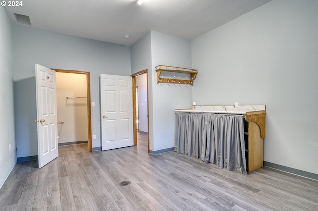 unfurnished bedroom with hardwood / wood-style floors