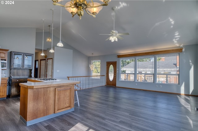 kitchen with a center island, dark wood-type flooring, high vaulted ceiling, decorative light fixtures, and ceiling fan