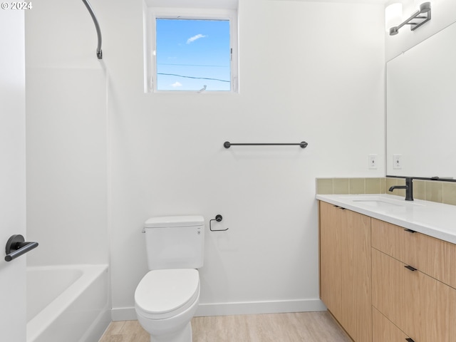 bathroom featuring hardwood / wood-style flooring, vanity, and toilet