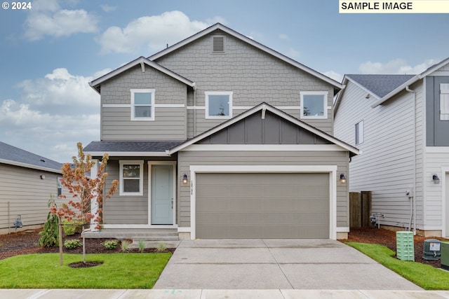 craftsman inspired home with a garage and a front yard