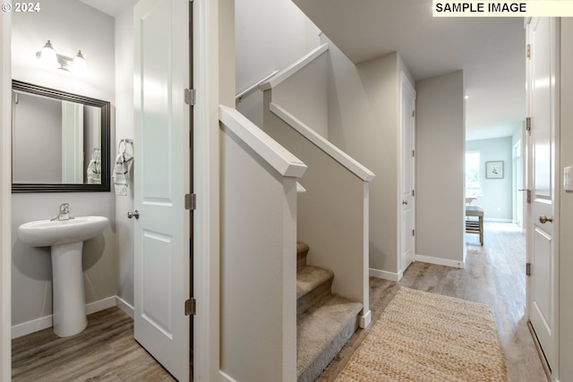 stairway with hardwood / wood-style floors