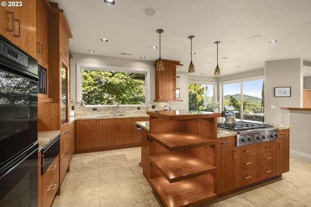 kitchen with black double oven, pendant lighting, backsplash, light tile floors, and light stone countertops