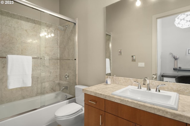 full bathroom featuring enclosed tub / shower combo, toilet, and vanity