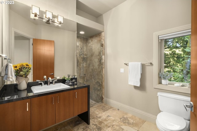 bathroom featuring a tile shower, tile floors, large vanity, and toilet