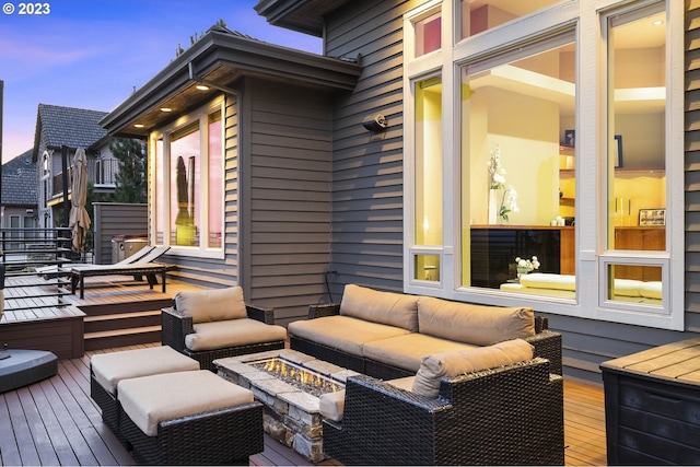 deck at dusk with outdoor lounge area