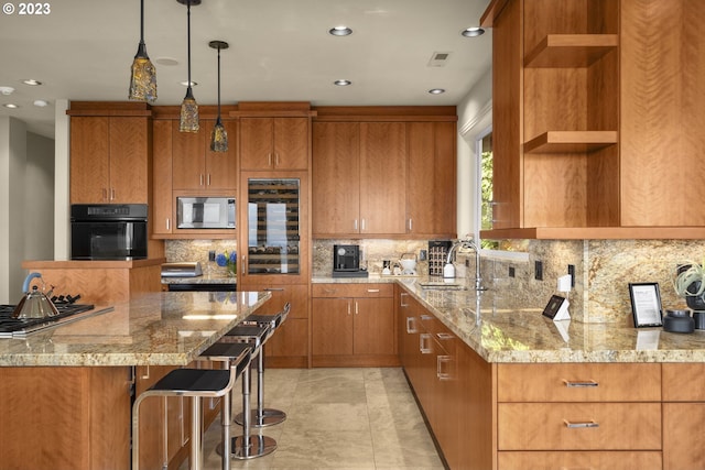 kitchen featuring a breakfast bar, light stone counters, tasteful backsplash, stainless steel appliances, and sink