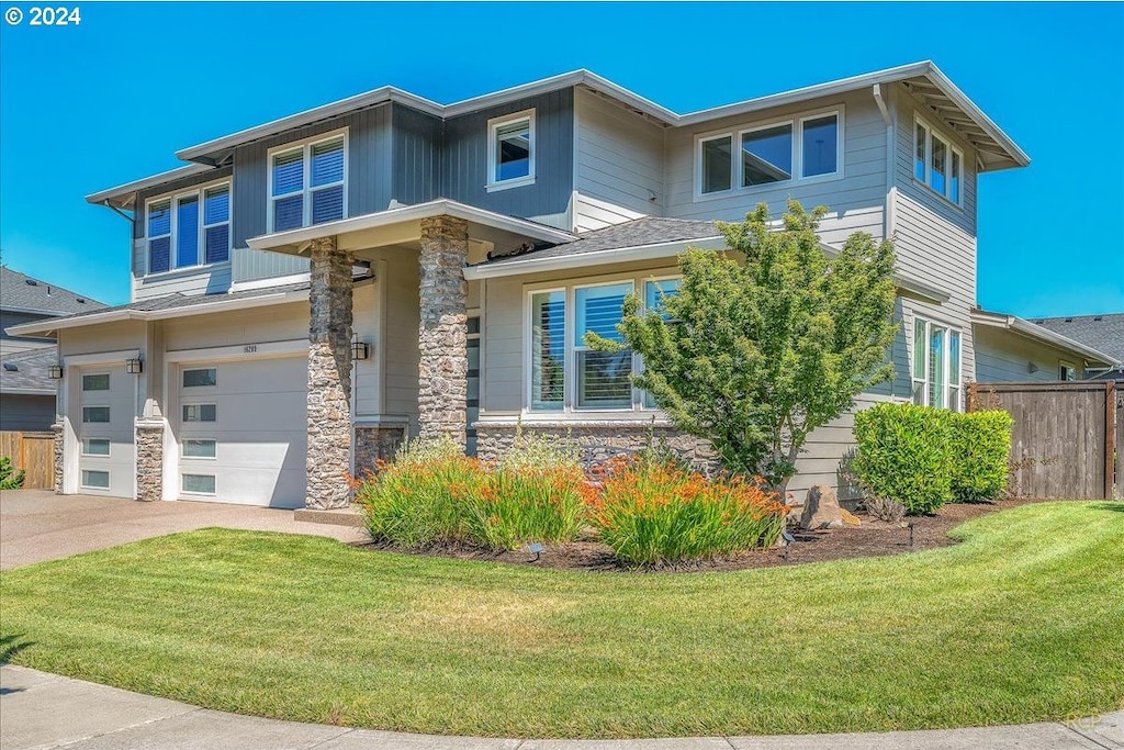 view of front of property with a garage and a front lawn