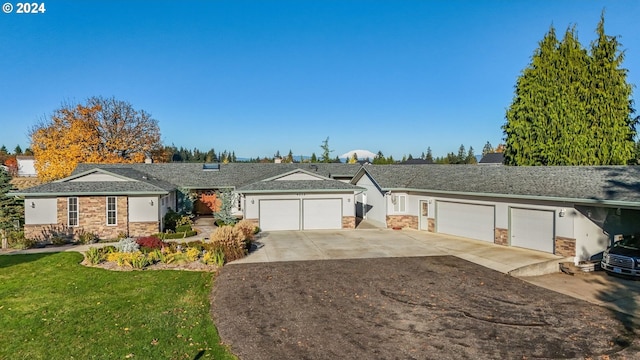 ranch-style home with a front lawn and a garage