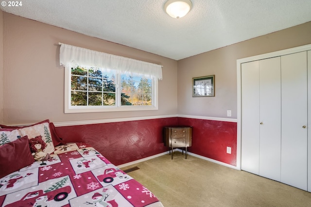 unfurnished bedroom with a textured ceiling, a closet, and carpet