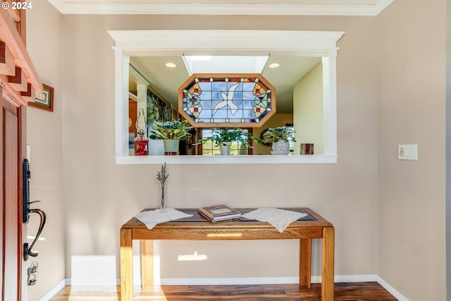 interior details with hardwood / wood-style flooring and ornamental molding