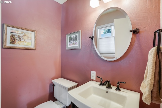 bathroom featuring toilet and sink