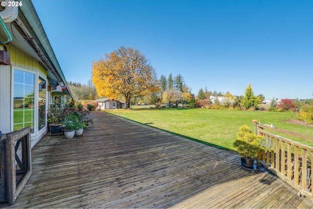 deck featuring a shed and a yard