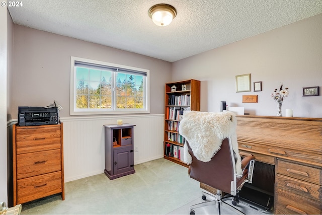 carpeted office with wooden walls and a textured ceiling