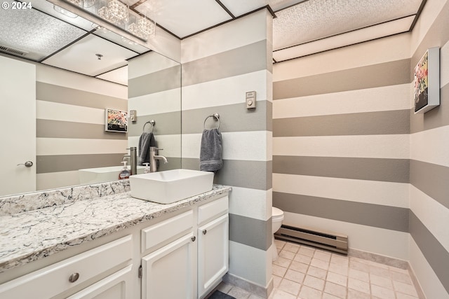 bathroom featuring vanity, toilet, and a baseboard heating unit