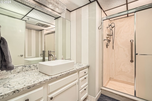 bathroom featuring walk in shower and vanity