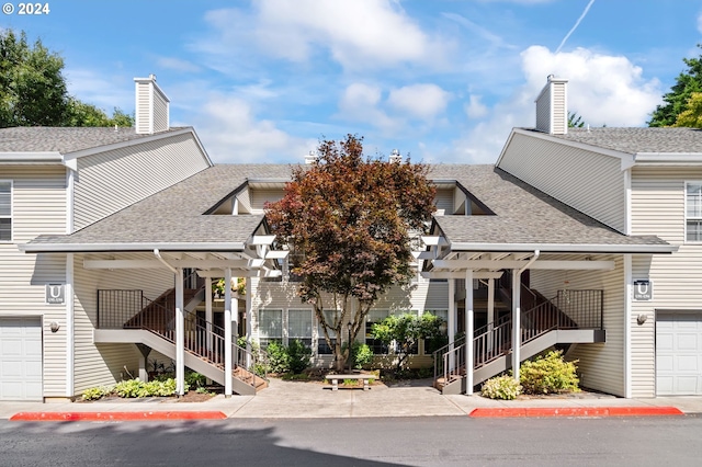 view of building exterior with a garage and stairway