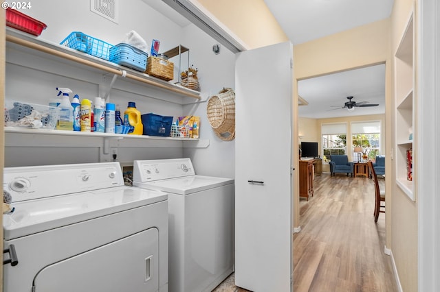 laundry room featuring washing machine and dryer, ceiling fan, and light hardwood / wood-style floors