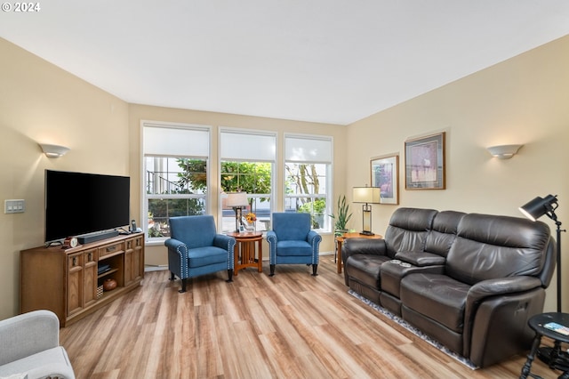 living room with light wood-type flooring and baseboards