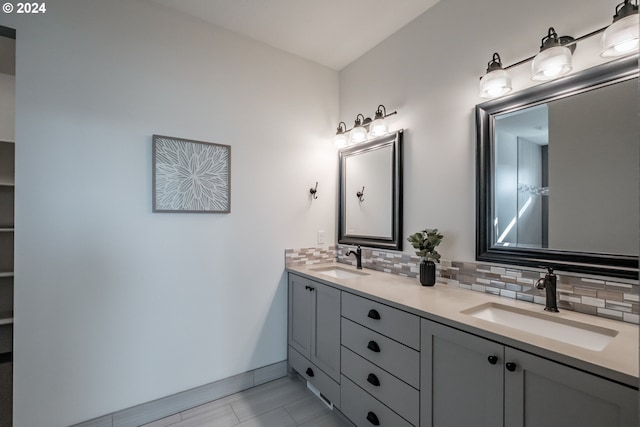 bathroom with vanity and tasteful backsplash