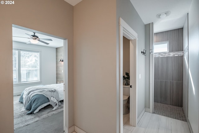 bathroom with a shower, ceiling fan, and toilet