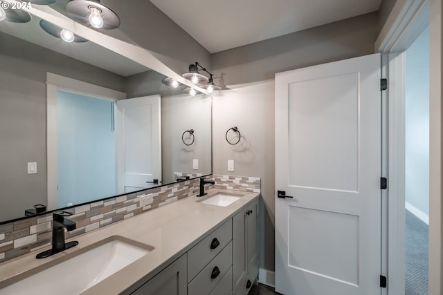 bathroom featuring decorative backsplash and vanity