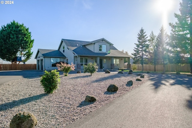 view of front of home featuring a porch and a garage