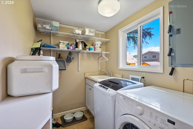 clothes washing area with cabinets, sink, washer and clothes dryer, and light tile patterned flooring