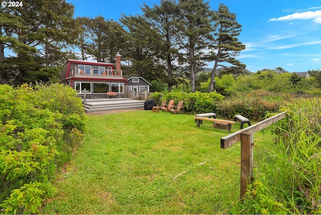 view of yard featuring an outbuilding and a wooden deck