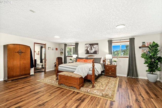 bedroom featuring multiple windows, wood finished floors, and baseboards