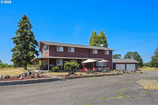 view of front of home featuring a garage and an outdoor structure