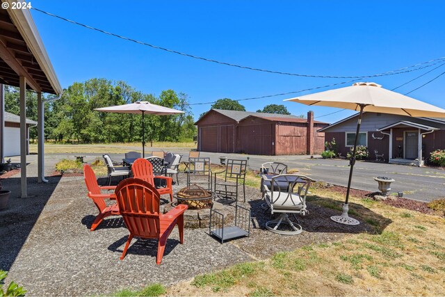 view of yard featuring a fire pit and an outdoor structure