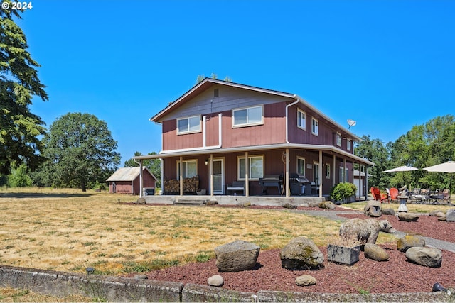 rear view of property featuring a lawn