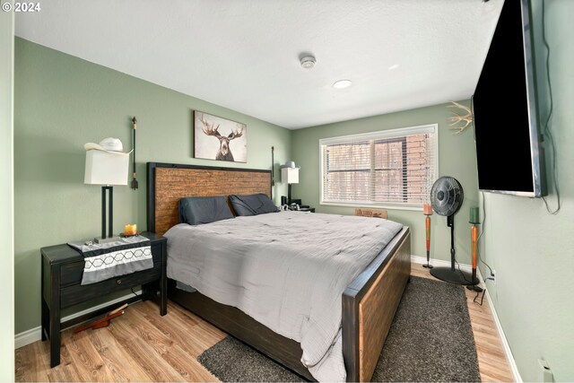 bedroom featuring light wood-type flooring and baseboards