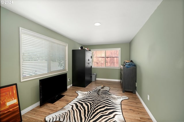 bedroom with light wood-style floors and baseboards