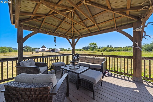 deck featuring a gazebo, a rural view, and outdoor lounge area