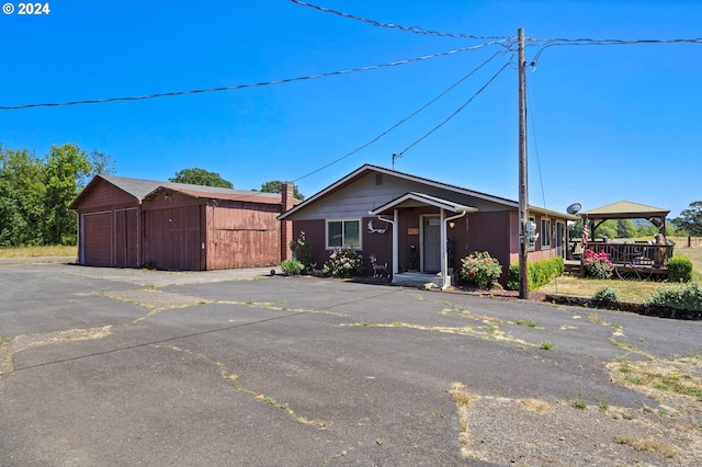 view of front of property with an outdoor structure and a garage